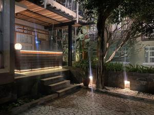 a building with stairs and lights in front of it at Regato Suites in Jakarta
