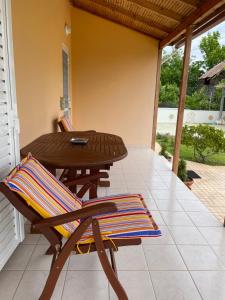 a patio with a table and chairs on a porch at Thalassa Hideaway in Dhiminión