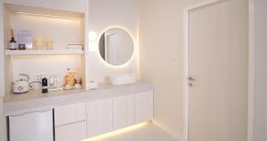 a white bathroom with a sink and a mirror at Sawasdee Coco in Ko Samed