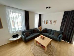 a living room with a couch and a table at CHATA KVETINKA in Martin