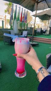 a person holding a pink drink in a glass at Hor Moheb Hotel in Cairo +42 photos