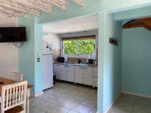 a kitchen with a white refrigerator and a window at BOG Las Frutillas in Villa La Angostura