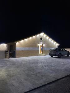 a car parked in front of a building with lights at Gernath farm in Ajloun