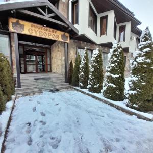 a building with snow in front of it at VIP apartmens Suvorov 1 in Bansko