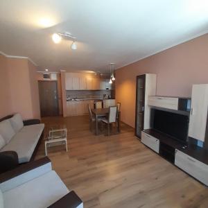 a living room with a couch and a dining room at VIP apartmens Suvorov 1 in Bansko