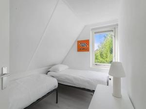 Llit o llits en una habitació de Holidayhouse Zeeland
