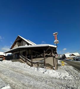 un edificio ricoperto di neve con un cartello sopra di Palaga Bukovel a Bukovel