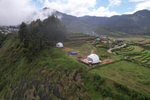 an aerial view of tents on a hill with a mountain at Kanal Glamp Kodaikanal Luxuries in Kodaikānāl