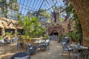 a restaurant with tables and chairs in a conservatory at La Sultana Oualidia in Oualidia