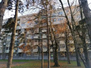 an apartment building with trees in front of it at Azulejo Apartment in Novi Beograd