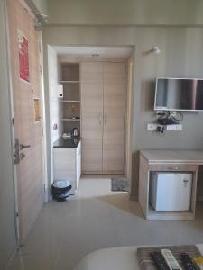 a room with a kitchen with a television and a counter at Omaxe krishna luxury stays in Vrindāvan