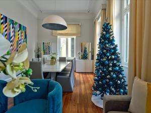 a christmas tree in the middle of a living room at The White House in Plaka by JJ Hospitality in Athens