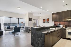 an open kitchen and living room in a house at Sophisticated & Classy stay at The Onyx in Dubai