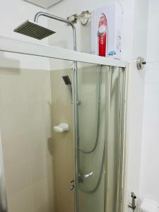 a shower in a bathroom with a glass shower stall at Ever Stays at Light Residences 1BR in Manila