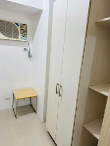 a small room with a microwave and a table at Ever Stays at Light Residences 1BR in Manila