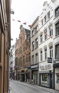 a city street with many buildings on a street at Hotel Agora Brussels Grand Place in Brussels