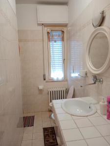 a white bathroom with a sink and a window at Villa di Pietro in Pescara