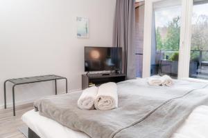 a bedroom with two white towels on a bed at Koje Seaside in Harrislee