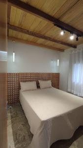 Ein Bett oder Betten in einem Zimmer der Unterkunft Pousada Vale da Neblina