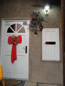 a white door with a christmas wreath on it at Apartman Nikola in Rakovac