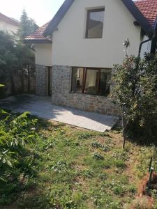 a house with a lawn in front of it at Pelister Riverside Villa in Bitola