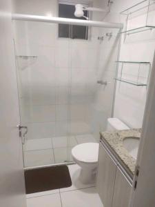 a bathroom with a shower and a toilet and a sink at Apartamento 3 Quartos - 807D in Contagem