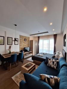 a living room with a blue couch and a table at Apartmani L6 & P90 Milmari Kopaonik in Kopaonik