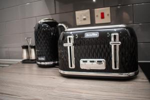 two toasters sitting on a counter in a kitchen at Exquisite 2-Bedroom City Centre Haven - Leicester's Premier Urban Retreat in Leicester