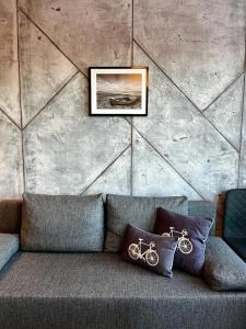 a couch with pillows and a picture on a wall at NOWOCZESNY APARTAMENT MODERNO 2020 - Szczecinek in Szczecinek