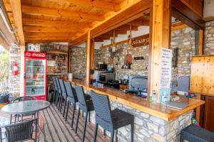 a bar in a restaurant with chairs and a counter at Villa Nina Adult only in Skiathos