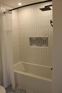 a white bath tub in a bathroom with a toilet at 4 Guest Suite with Waterfront Views at Fancie's PEC - Suite 2 in Belleville +52 photos