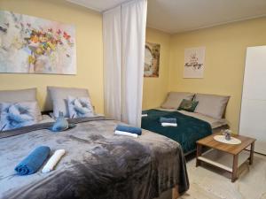 a bedroom with two beds and a table at Veludo Apartments Centrum free parking in Banská Bystrica