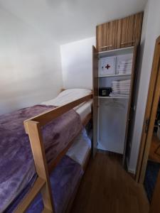 a small bedroom with a bunk bed and a refrigerator at Apartman Moj mir Jahorina in Jahorina