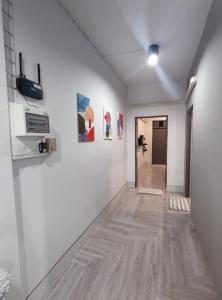 a hallway with white walls and a wooden floor at 106 MAIN STREET by ZamanJa Betong in Betong