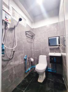 a bathroom with a shower and a toilet and a sink at 106 MAIN STREET by ZamanJa Betong in Betong