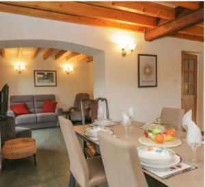 a living room with a table and a couch at The Drumlins Cottage in Ulverston
