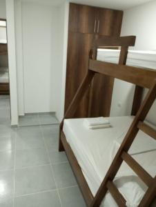 a wooden bunk bed in a room with a tiled floor at Apartamento Villa Mary-Coveñas in Coveñas