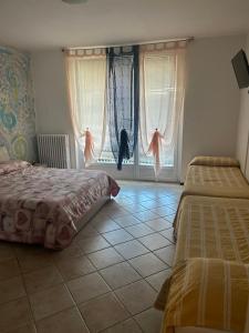 Postel nebo postele na pokoji v ubytování Albergo La Grolla