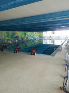 a gym with a ping pong table in a room at La Casa Shabby in Marilleva