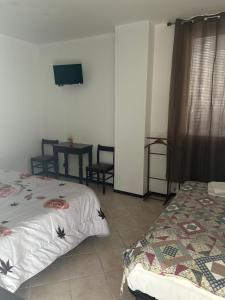 Postel nebo postele na pokoji v ubytování Albergo La Grolla