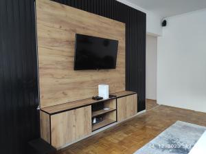 a living room with a flat screen tv on a wall at Azer in Sarajevo