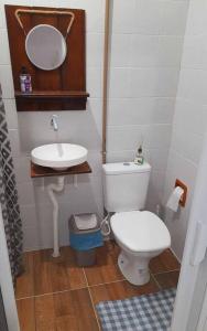 a small bathroom with a toilet and a sink at Casa térrea no centro próximo a praia! in Balneário Camboriú
