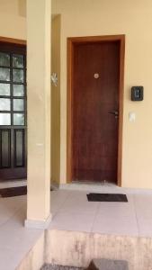 brązowe drzwi w budynku z podłogą wyłożoną kafelkami w obiekcie Suite 1 a 80 metros do mar de Itamambuca, Ubatuba w mieście Ubatuba