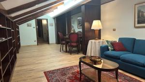 a living room with a blue couch and a table at Hotel Roma in Bologna