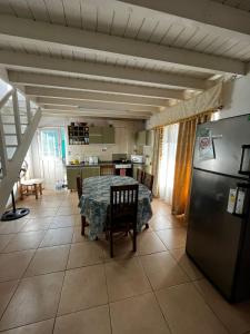 a kitchen and dining room with a table and a refrigerator at Complejo La Rosa Molinari Cosquin in Córdoba