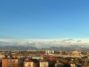 a view of a city with mountains in the background at Skyscraper 11 in Cinisello Balsamo +27 photos
