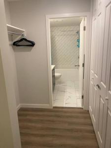 a bathroom with a toilet and a walk in shower at Spacious 2-bed, 2-bath condo in downtown Kelowna! in Kelowna
