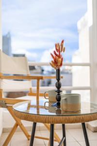 a glass coffee table with a vase on top of it at Olympian Goddess Demetra in Heraklio Town