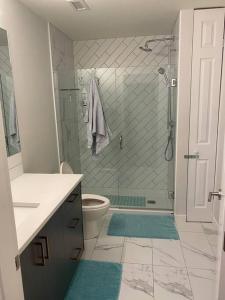 a bathroom with a shower and a toilet at Spacious 2-bed, 2-bath condo in downtown Kelowna! in Kelowna