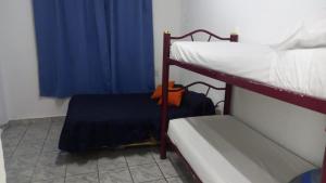 a bedroom with two bunk beds and a blue curtain at El Cordobés in San Juan
